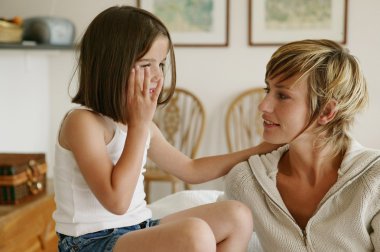 Little girl whispering secrets to her mom clipart