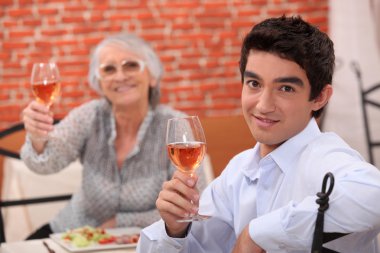 Man and grandmother in restaurant clipart