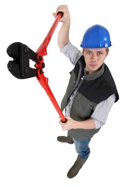 Unfriendly tradesman holding up a pair of clippers — Stock Photo, Image