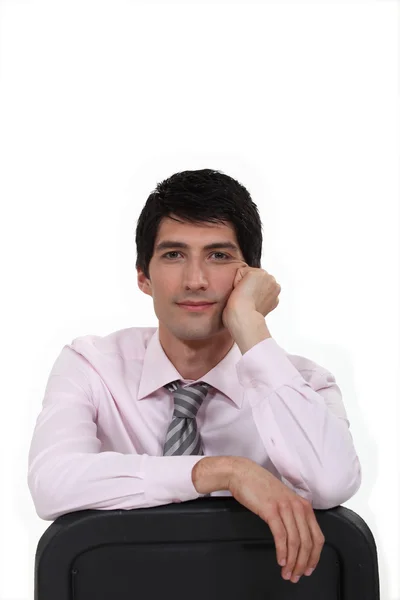 stock image Young man leaning back in chair