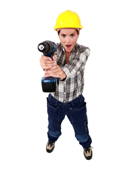 A female construction worker using a drill as a gun. — Stock Photo, Image
