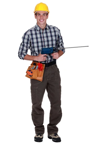 Handwerker hält ein Elektrowerkzeug in der Hand — Stockfoto