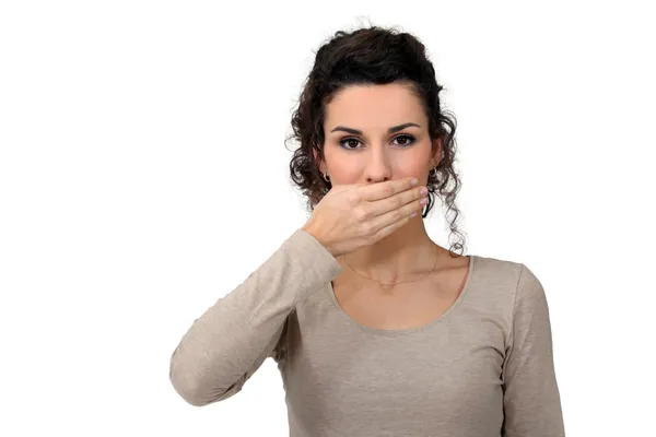 Woman with hand over mouth Stock Photo