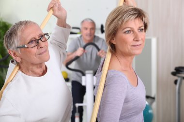 Mature women in fitness center clipart