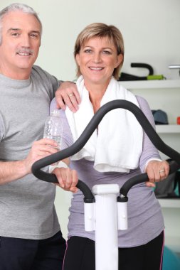 Mature couple resting after fitness clipart