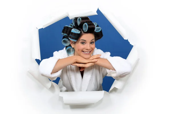 Young woman with curlers in her hair posing — Stock Photo, Image