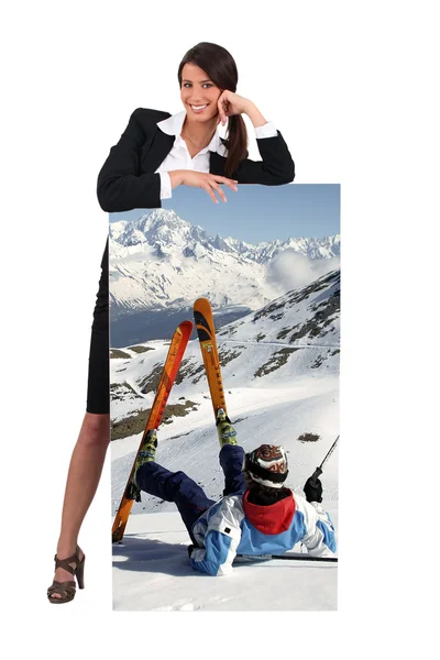 Woman with picture of skier falling in the snow — Stock Photo, Image
