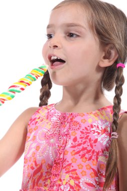 Little girl with multicolored lollipop clipart