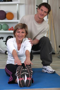 Middle-aged woman with personal trainer clipart