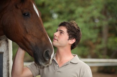 Portrait of a young man with horse clipart