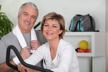Middle-aged couple going in for sport clipart