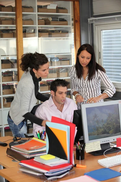 Groep van kantoorpersoneel kijken naar een computer — Stockfoto
