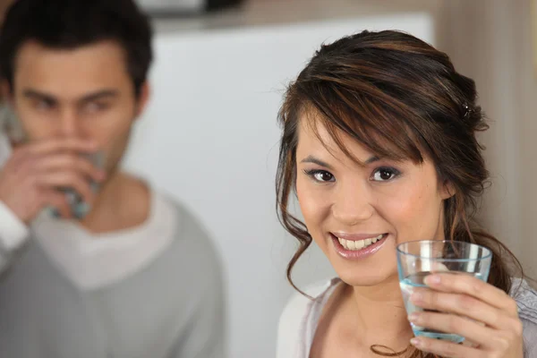 Couple drinking glass of water — Stock Photo, Image