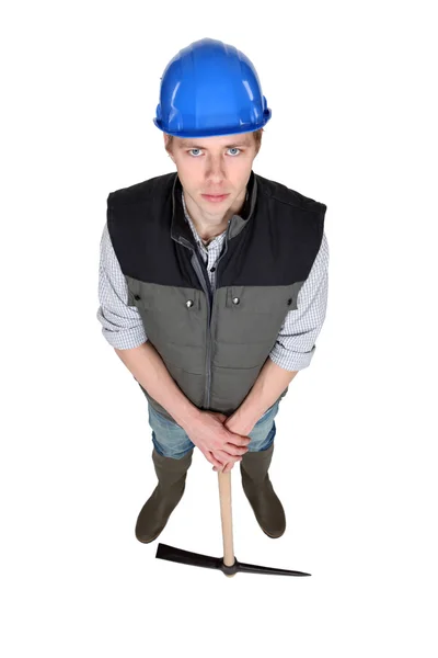 Young construction worker stood with pick-ax — Stock Photo, Image
