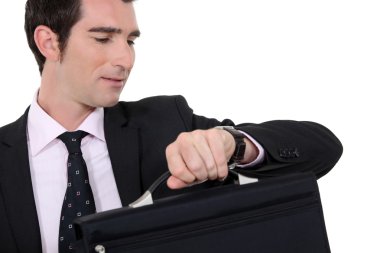 Businessman checking he is not late clipart