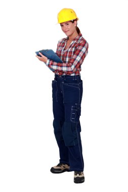 Tradeswoman holding a clipboard clipart