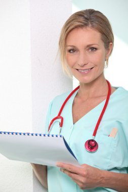 Female nurse holding paperwork clipart