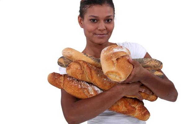 Young black woman holding a lot of bread in her arms — Stock Photo, Image