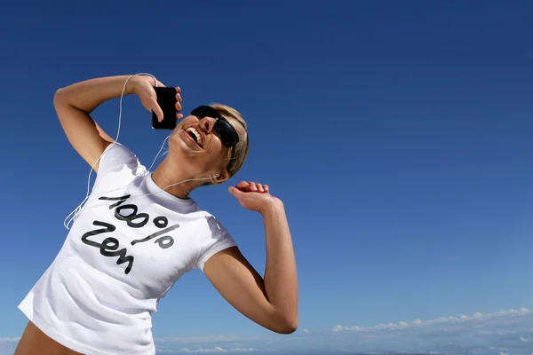 stock image Woman dancing while listening to her mp3 player