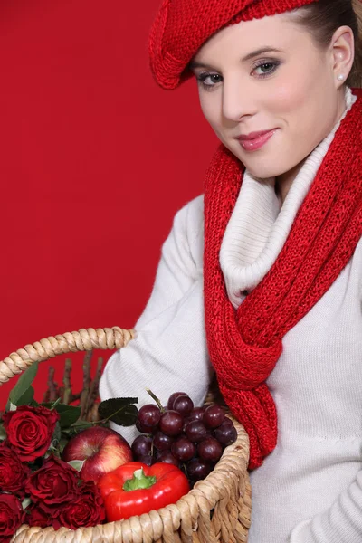 Woman in a red scarf and hat with red food and roses — Stock Photo, Image