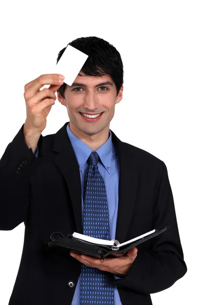 Executive with a blank businesscard and diary — Stock Photo, Image