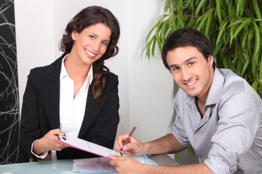 Female real estate agent and young man buying house clipart