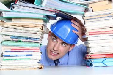 An architect worry about his folders construction. clipart