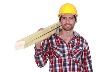 Tradesman carrying wooden planks clipart