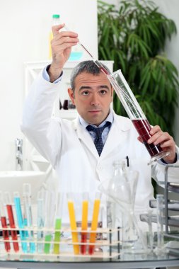 A scientist doing experiments in his laboratory clipart