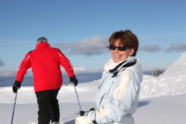 Couple enjoying a day out skiing clipart