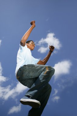 Young Afro-American guy jumping in the air clipart