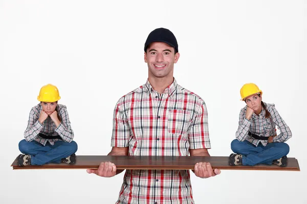 Construction manager balancing disgruntled staff — Stock Photo, Image