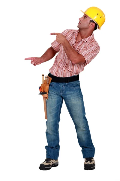 Workman pointing something on white background — Stock Photo, Image