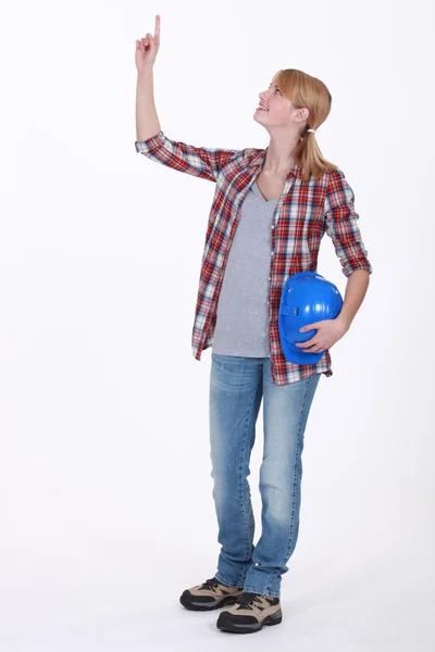 Tradeswoman pointing to the ceiling — Stock Photo, Image