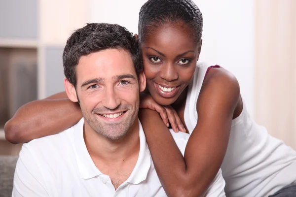 Landscape portrait of a mixed race couple indoors — Stock Photo, Image