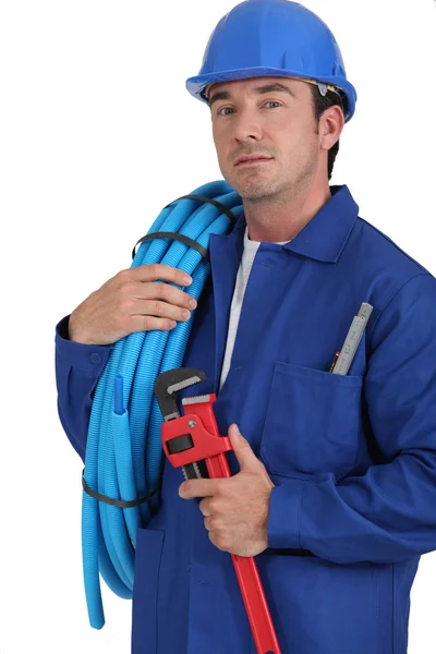 Operador con rollo de tubo azul —  Fotos de Stock