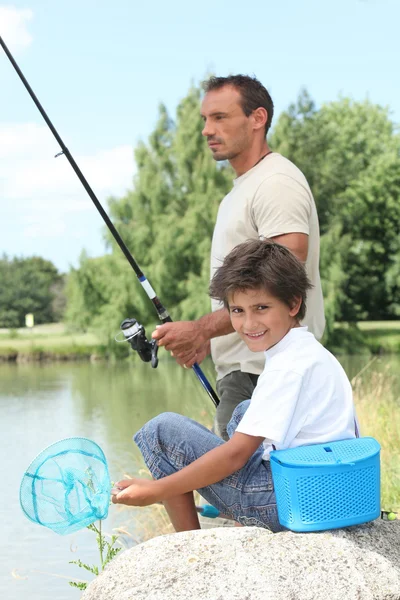 Father and son fishing at a lake — Stock Photo, Image
