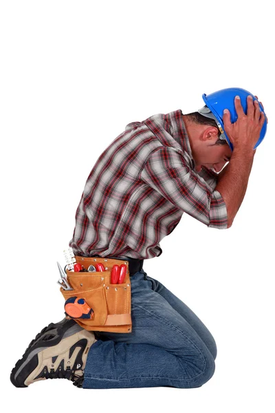 Furious craftsman on his knees — Stock Photo, Image