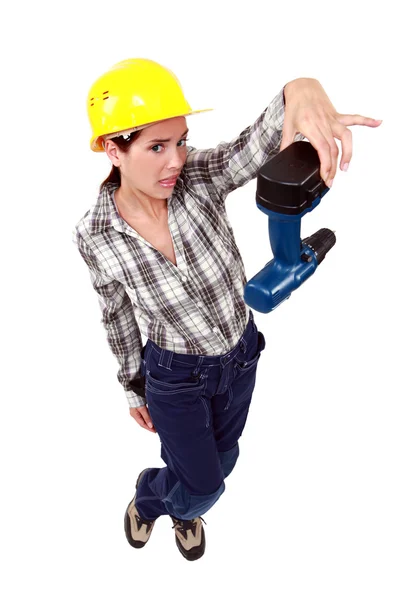 Confused woman holding drill — Stock Photo, Image