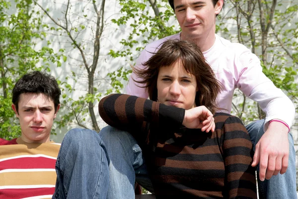 Moody teenagers posing with their father — Stock Photo, Image
