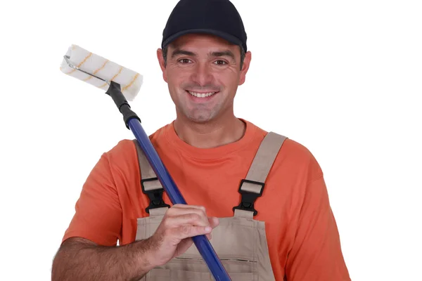 Man with extended paint roller — Stock Photo, Image