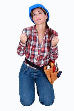 A desperate female construction worker. clipart