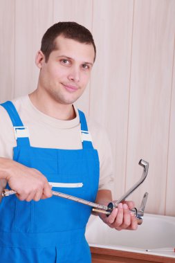 Artisan installing new tap in bathroom clipart