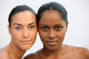 Head and shoulders of two beautiful women clipart