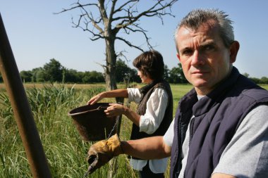 Farmer and wife in field clipart