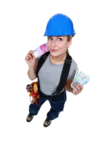 Female electrician with cash — Stock Photo, Image