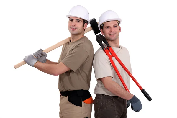 Trabajador de la construcción sosteniendo herramientas pesadas — Foto de Stock