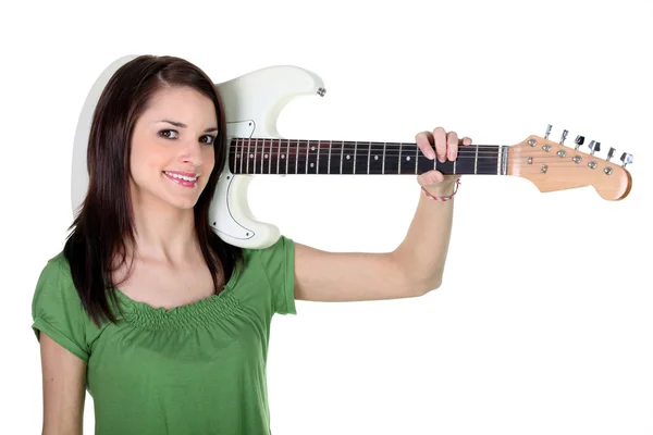 Girl carrying electric guitar over shoulder — Stock Photo, Image