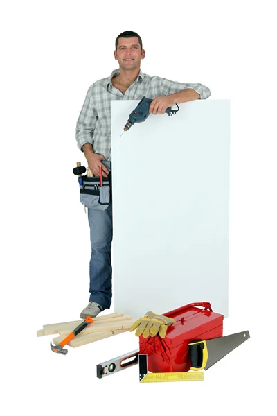 Handyman com ferramentas e placa de mensagem — Fotografia de Stock