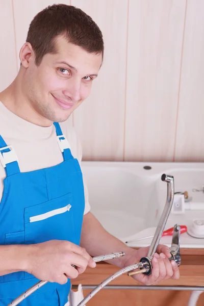 Plombier installant un robinet de cuisine — Photo